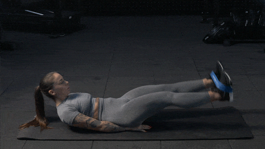  Вправа на піднімання прямих ніг з еспандером лежачи